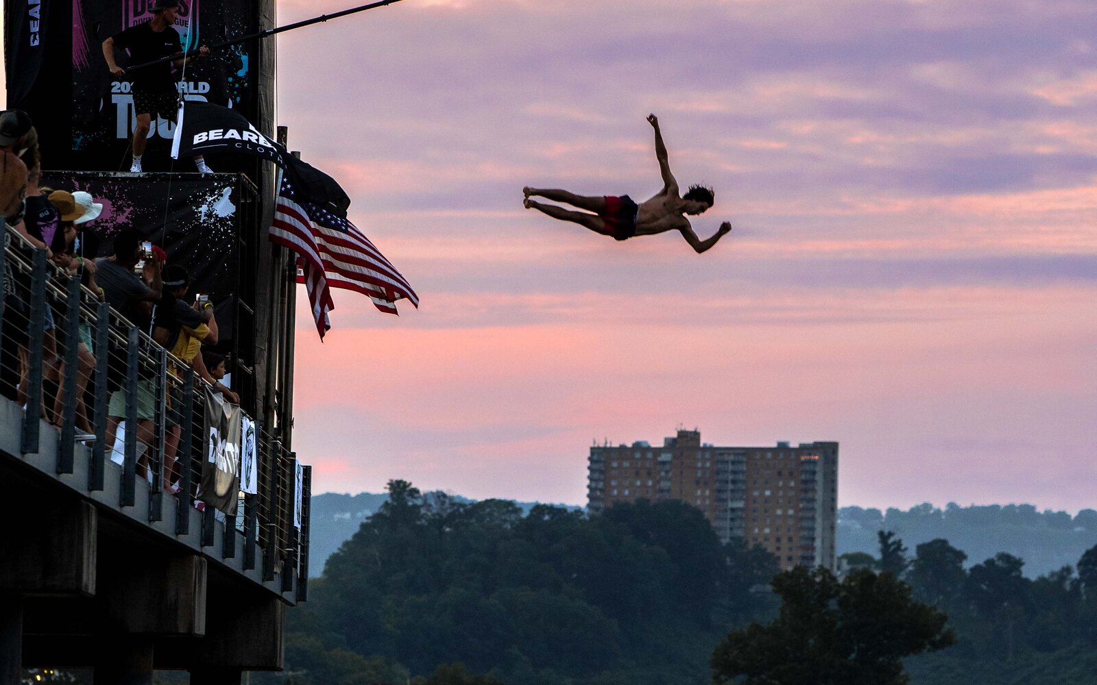 High diver mid-air over the Tennessee River at sunset, Chattanooga River Games